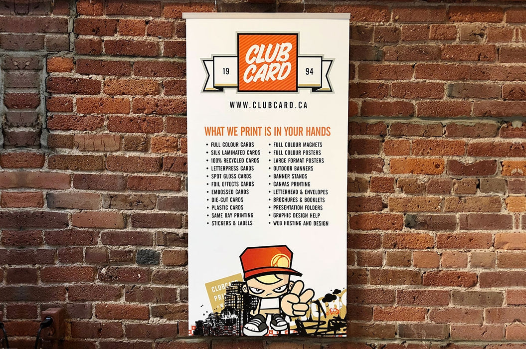 Clubcard mounted sign held by a silver sign rail on a brick wall.