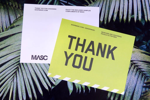 Custom 14pt uncoated matte postcards with white and bright yellow MASC Thank You card designs against a palm leaf background
