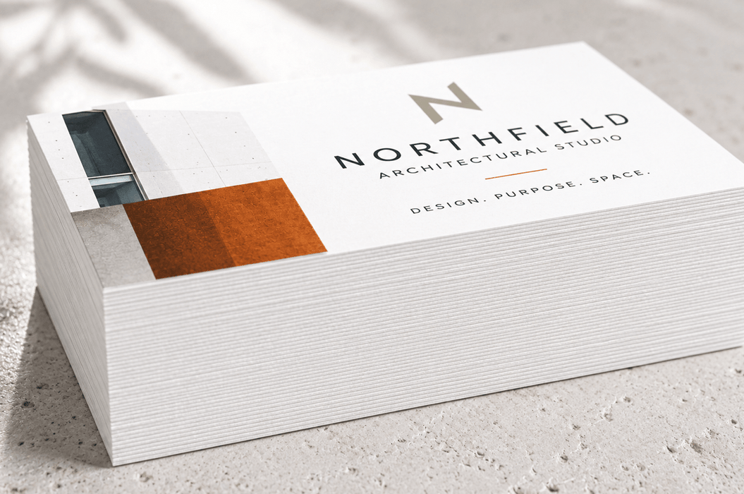 Stack of custom printed 24pt recycled uncoated business cards for Northfield Architectural Studio showing extra thick paper edge quality