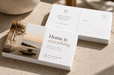 Front and back view of custom size 24pt recycled uncoated postcards featuring Haven Real Estate branding and modern interior design artwork