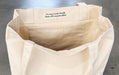 Interior view of heavyweight recycled cotton tote bag showing inside pocket and eco-friendly tag