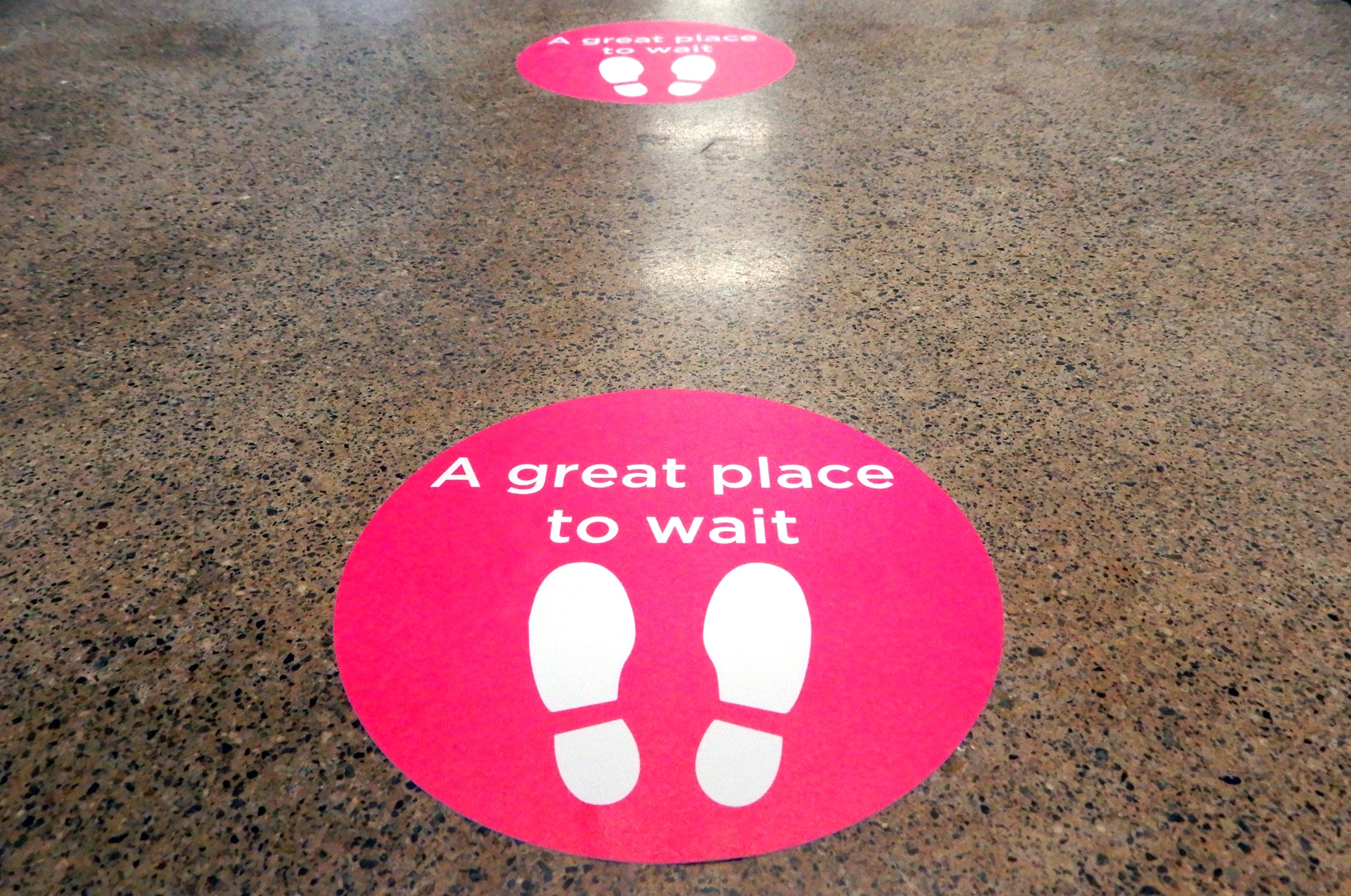 Custom floor sticker printing for social distancing on durable vinyl in full color for Low Tide Properties.