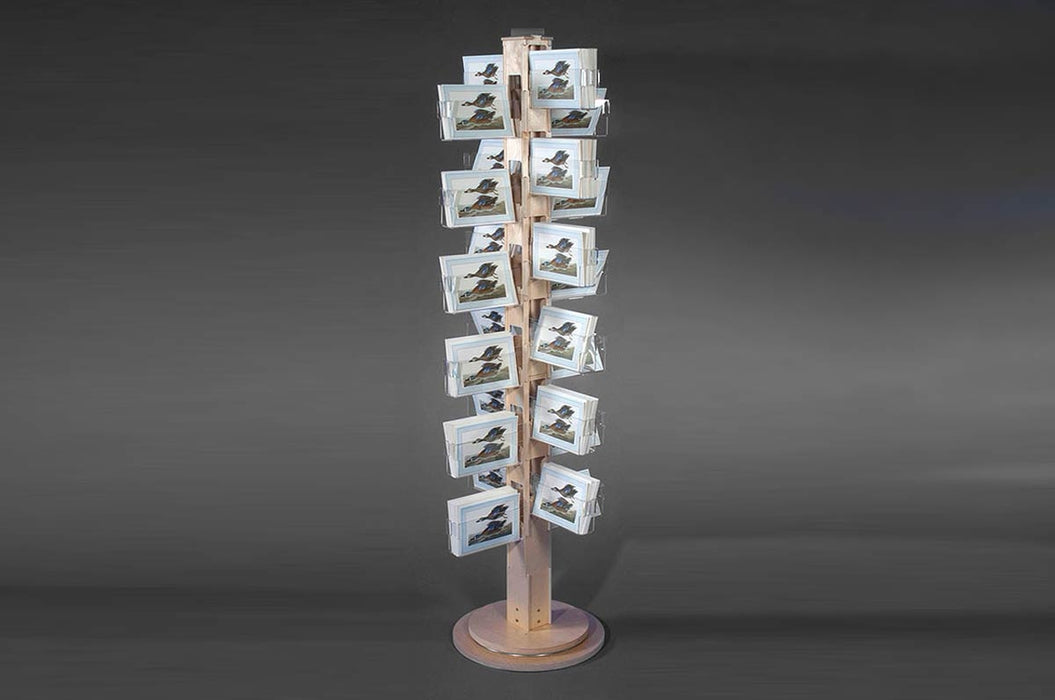 Birch plywood floor card spinner display with 24 clear acrylic pockets holding various greetin cards.