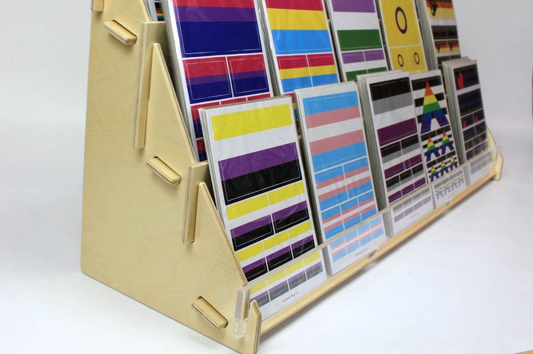 Close up of the side of a large birch plywood 3-tier card display rack with acrylic front panel holding sticker sheets.