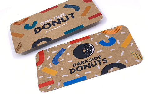 Custom business cards for Darkside Donuts printed in full color and white ink on 24pt chipboard Kraft stock | All four corners are rounded | Clubcard Printing USA